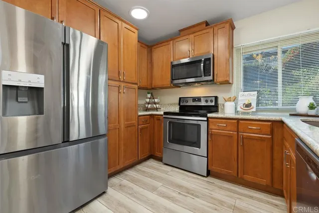 a kitchen with stainless steel appliances a refrigerator stove and microwave