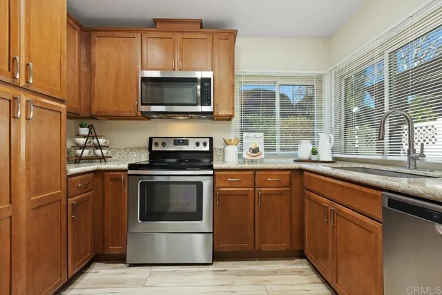 a kitchen with granite countertop a sink and steel stainless steel appliances