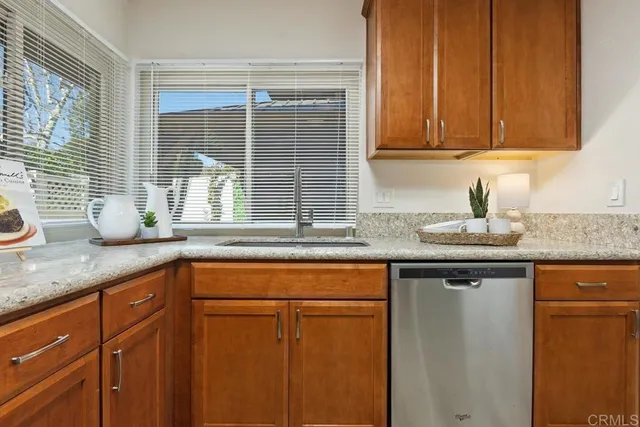 a kitchen with granite countertop cabinets sink and window