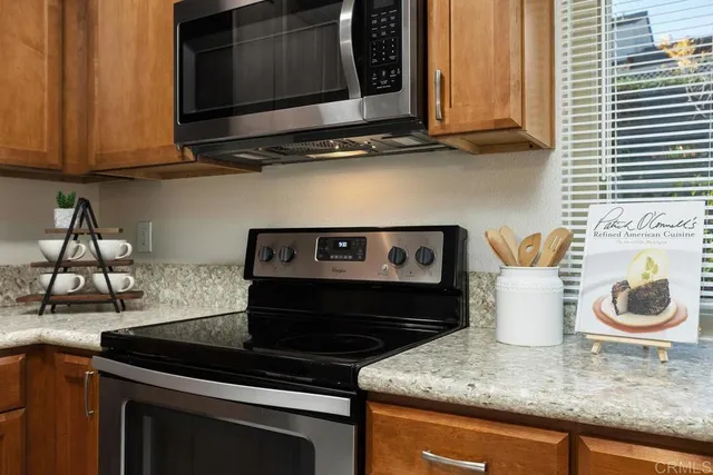 a kitchen with granite countertop a stove and a sink
