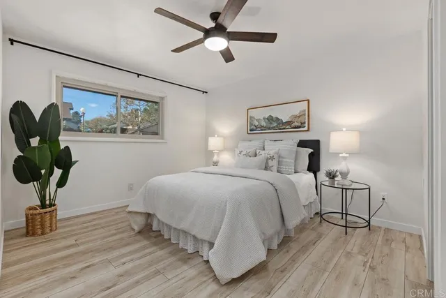 a bedroom with a bed and a painting on the wall