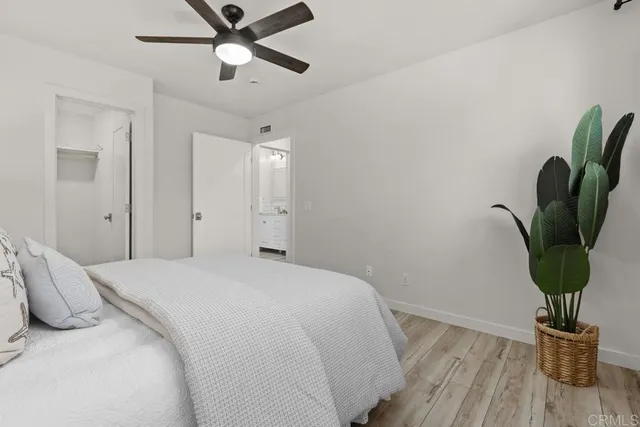 a bedroom with a bed and wooden floor