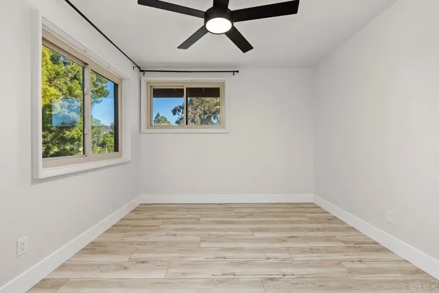 a view of room with window and wooden floor