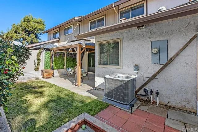 a view of a patio with table and chairs with wooden floor and fence