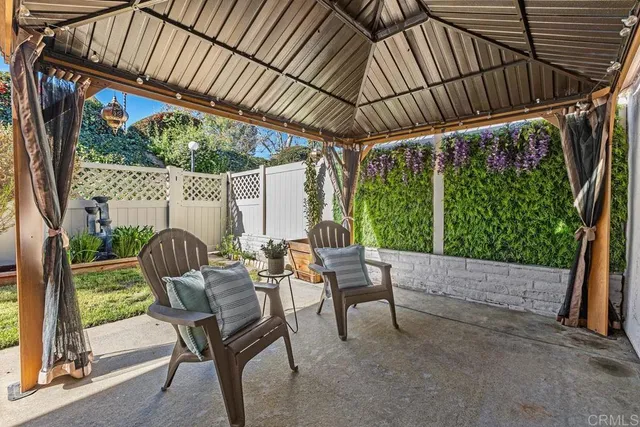 a patio with glass top table and chairs