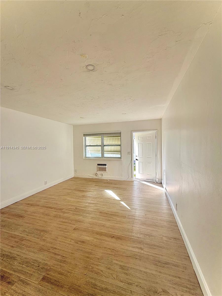 224 Southwest 10th Street, Unit 1 Hallandale Beach, FL 33009 - Photo 11 of 22 a view of empty room with wooden floor
