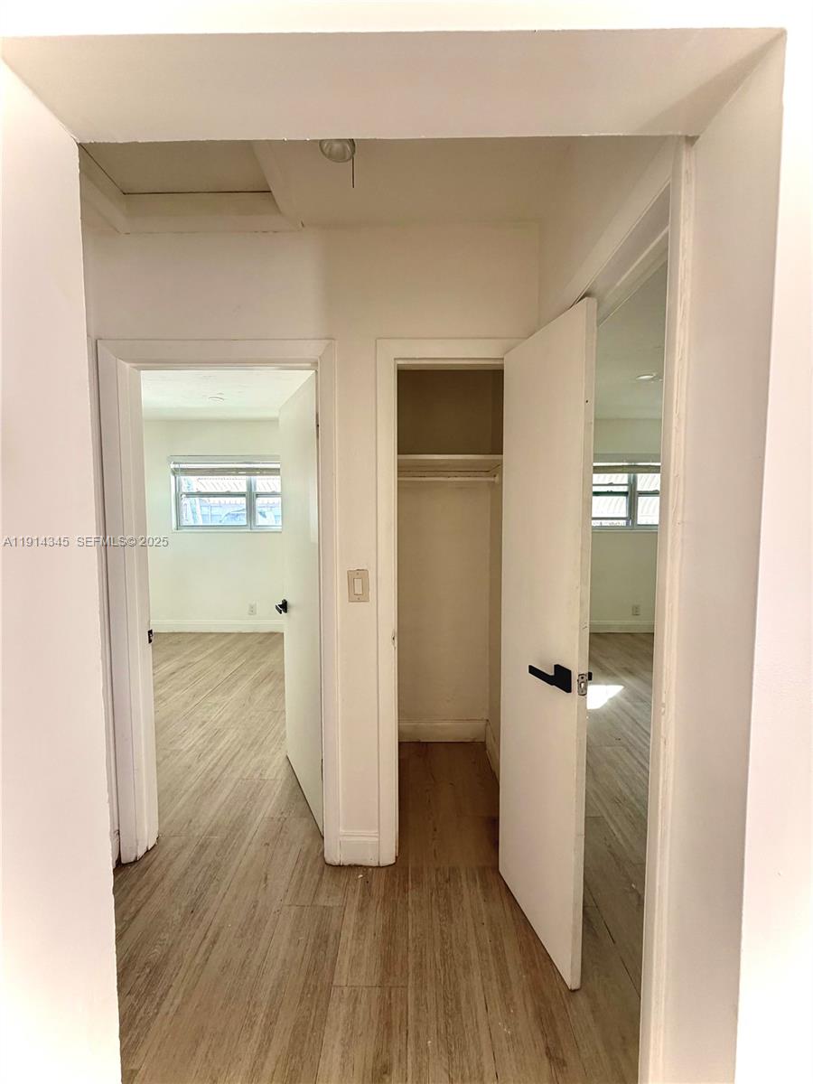 224 Southwest 10th Street, Unit 1 Hallandale Beach, FL 33009 - Photo 13 of 22 a view of a hallway with wooden floor