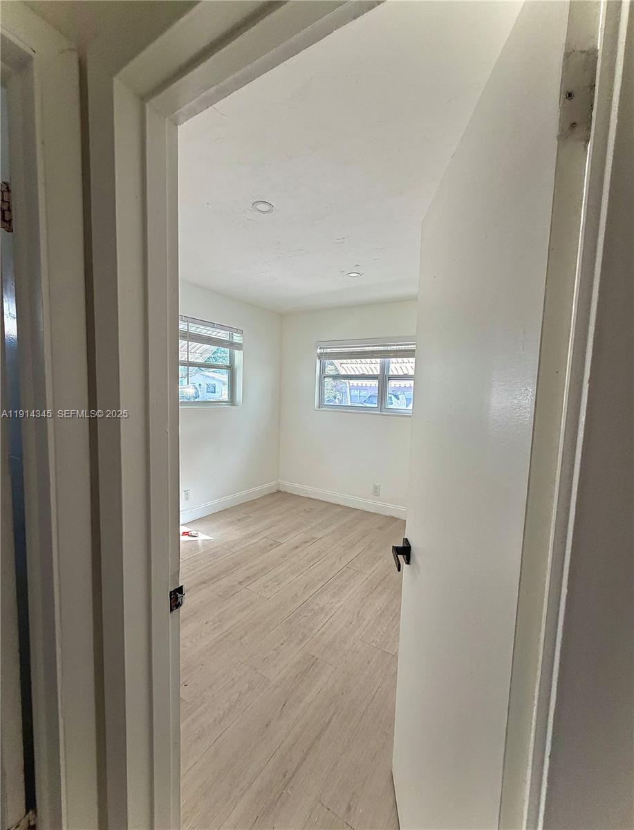 224 Southwest 10th Street, Unit 1 Hallandale Beach, FL 33009 - Photo 17 of 22 a view of an empty room with a window