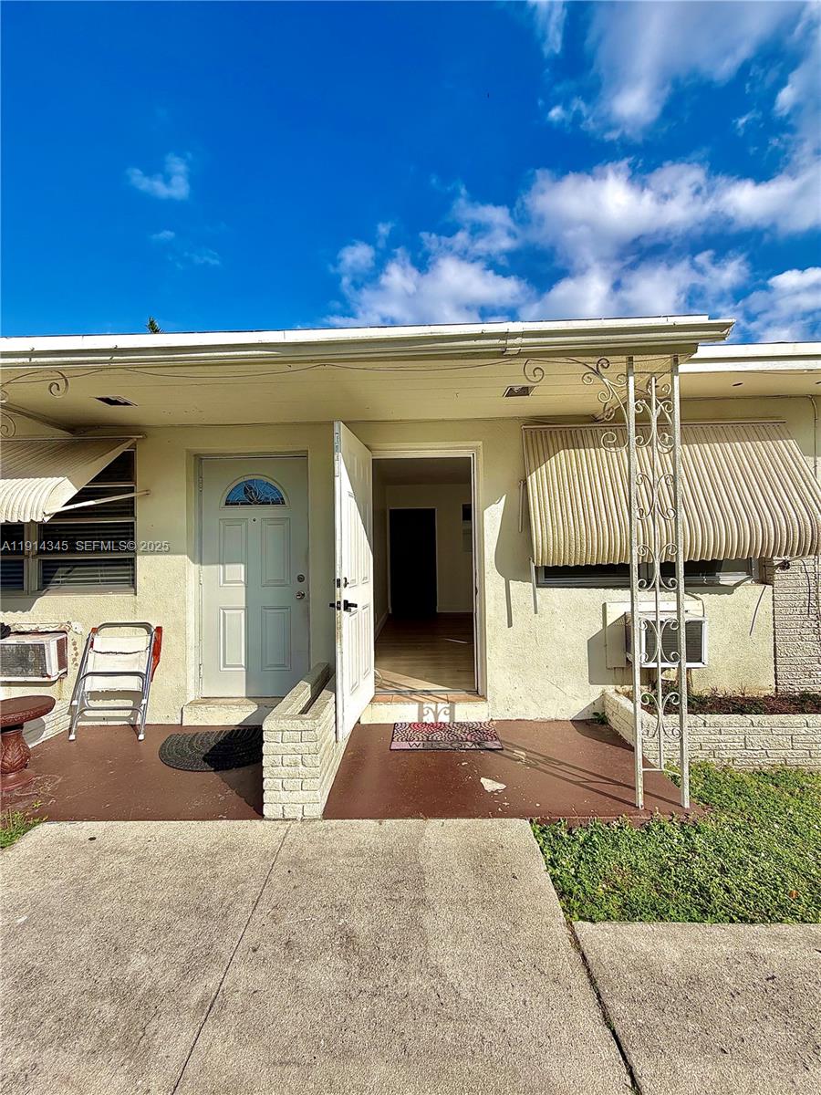 224 Southwest 10th Street, Unit 1 Hallandale Beach, FL 33009 - Photo 2 of 22 a patio with a table and chairs