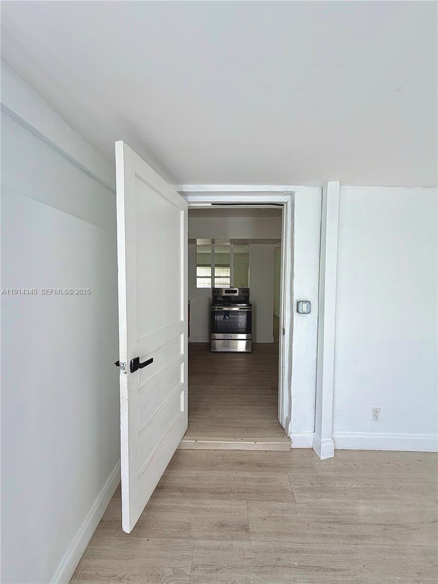 224 Southwest 10th Street, Unit 1 Hallandale Beach, FL 33009 - Photo 5 of 22 a view of a livingroom from a hallway