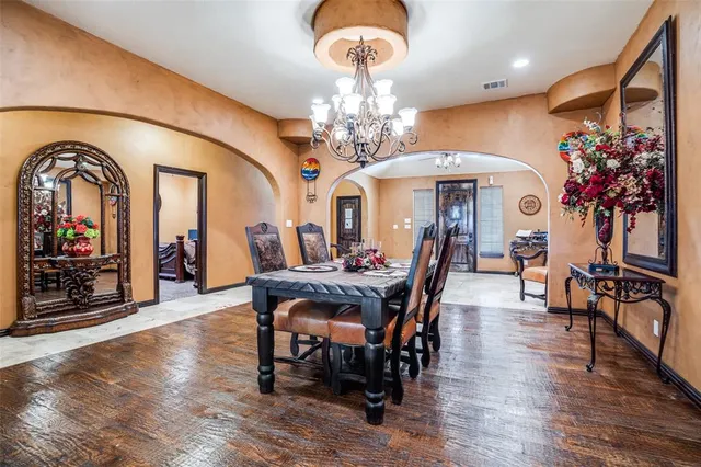a view of a dining room with furniture and chandelier
