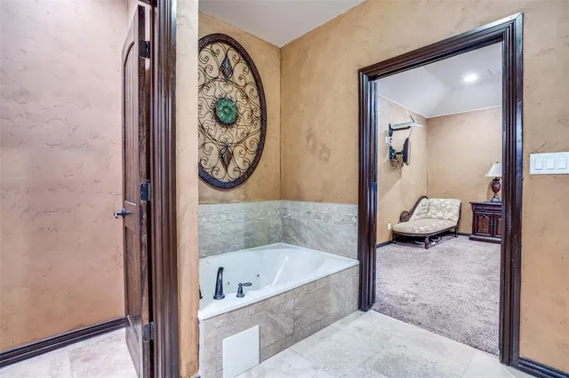 a bathroom with a tub and a view of bathroom