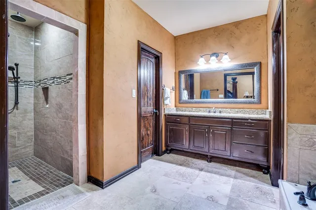 a bathroom with a sink a mirror and a shower