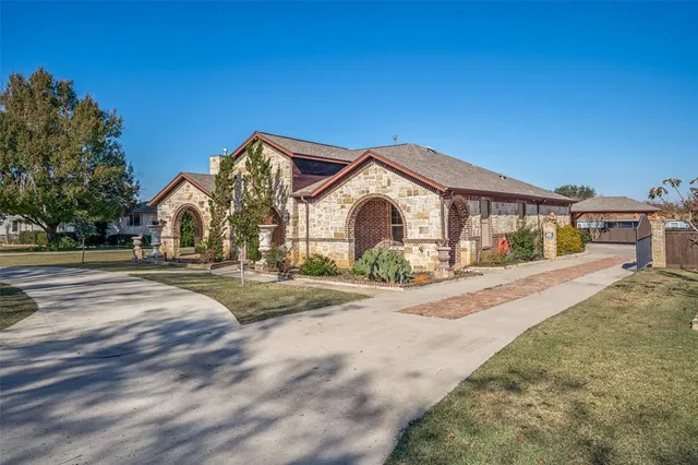 a view of house with outdoor space and parking
