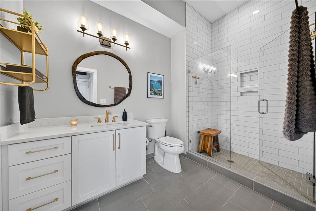 22 Airline Street Southeast, Unit PH403 Atlanta, GA 30312 - Photo 24 of 61 a bathroom with a toilet sink double vanity and mirror