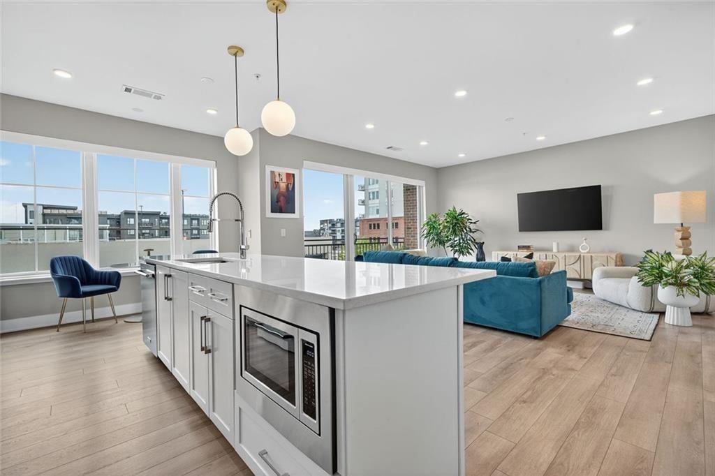 22 Airline Street Southeast, Unit PH403 Atlanta, GA 30312 - Photo 3 of 61 a kitchen with stainless steel appliances granite countertop a stove and a wooden floors