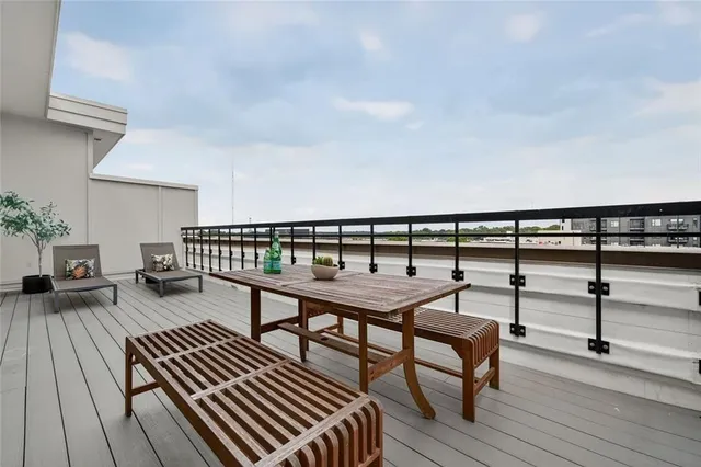 a view of a chairs and table in the balcony