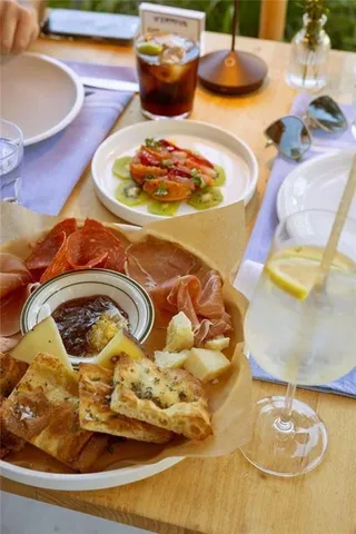a living room with patio furniture and a potted plant