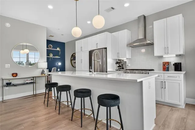 a kitchen with cabinets a sink dining table and chairs