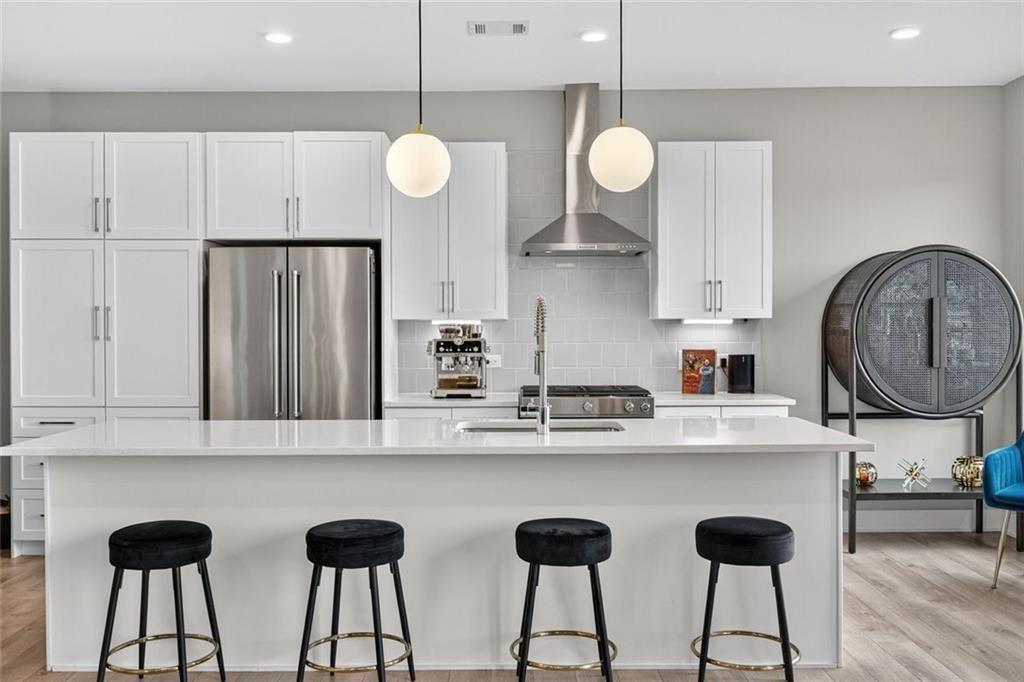 22 Airline Street Southeast, Unit PH403 Atlanta, GA 30312 - Photo 7 of 61 a kitchen with stainless steel appliances a table chairs and a chandelier
