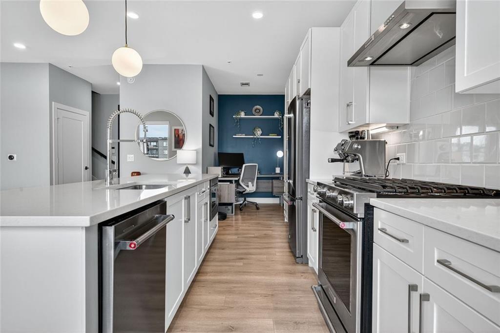 22 Airline Street Southeast, Unit PH403 Atlanta, GA 30312 - Photo 9 of 61 a kitchen with stainless steel appliances a sink stove and cabinets