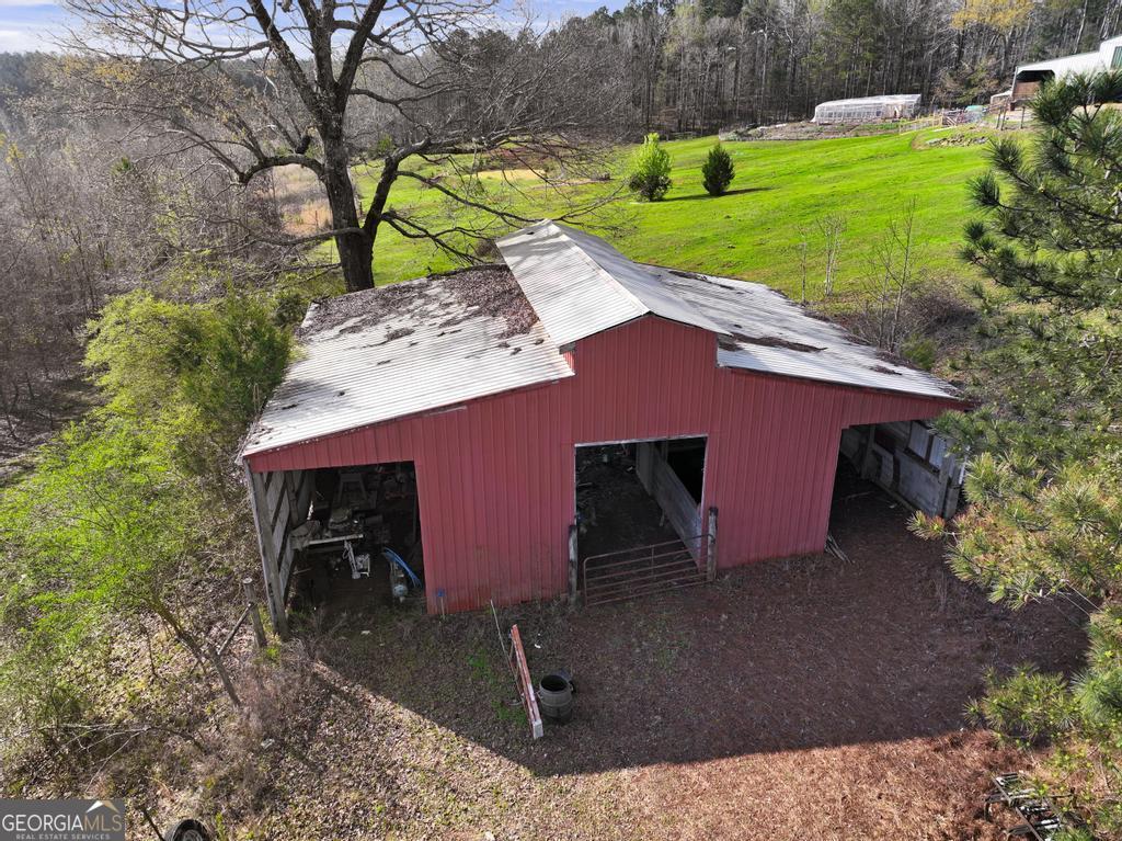 955 Mocassin Gap Road Locust Grove, GA 30248 - Photo 50 of 59 a view of a backyard with a barn