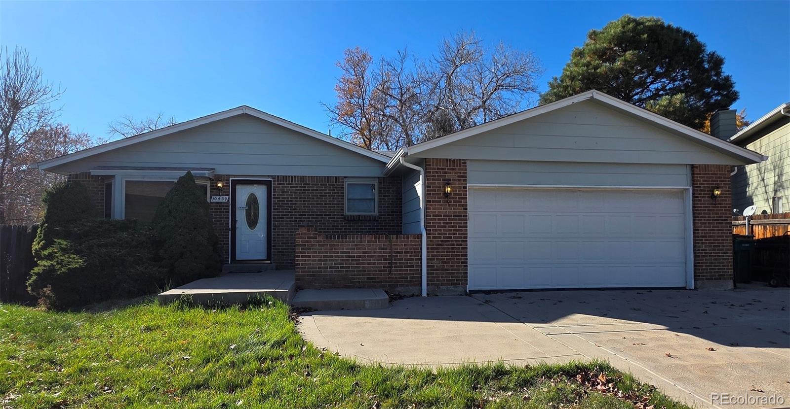 10439 Independence Street Broomfield, CO 80021 - Photo 1 of 30 a front view of a house with garden