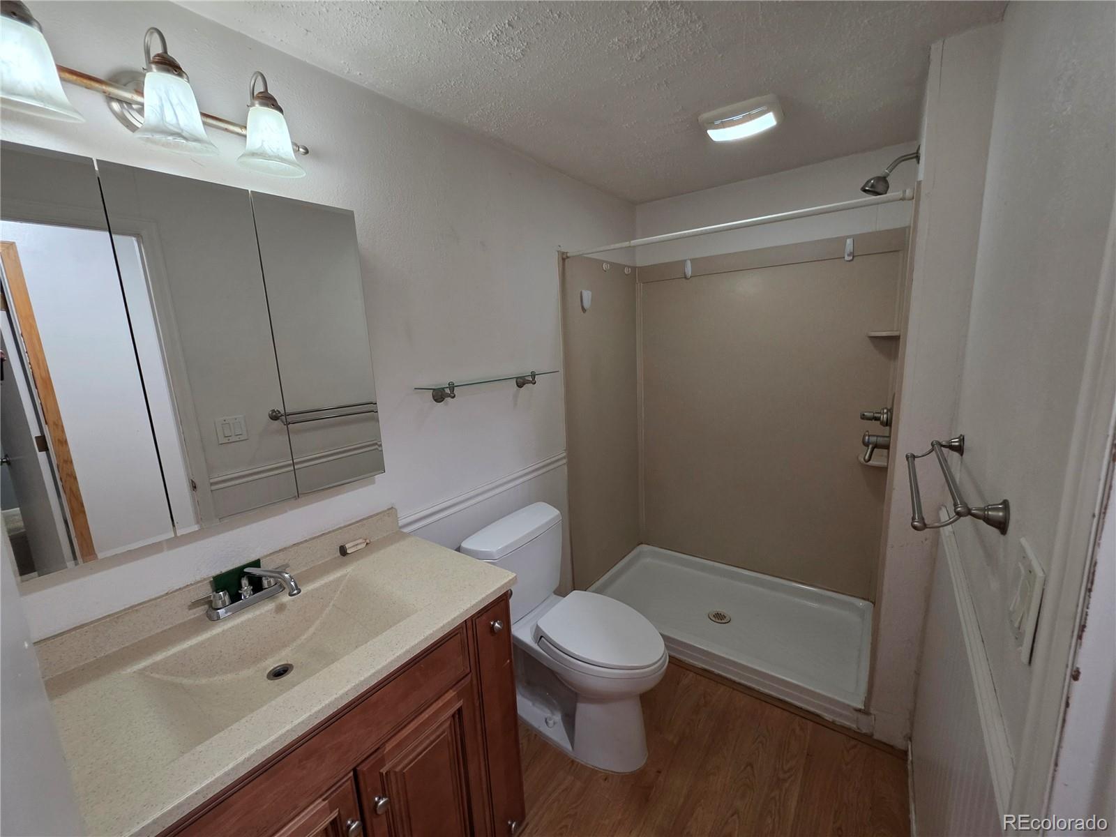 10439 Independence Street Broomfield, CO 80021 - Photo 11 of 30 a bathroom with a sink a toilet and shower