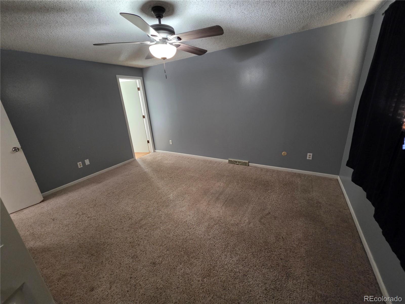 10439 Independence Street Broomfield, CO 80021 - Photo 13 of 30 en empty room with windows and fan