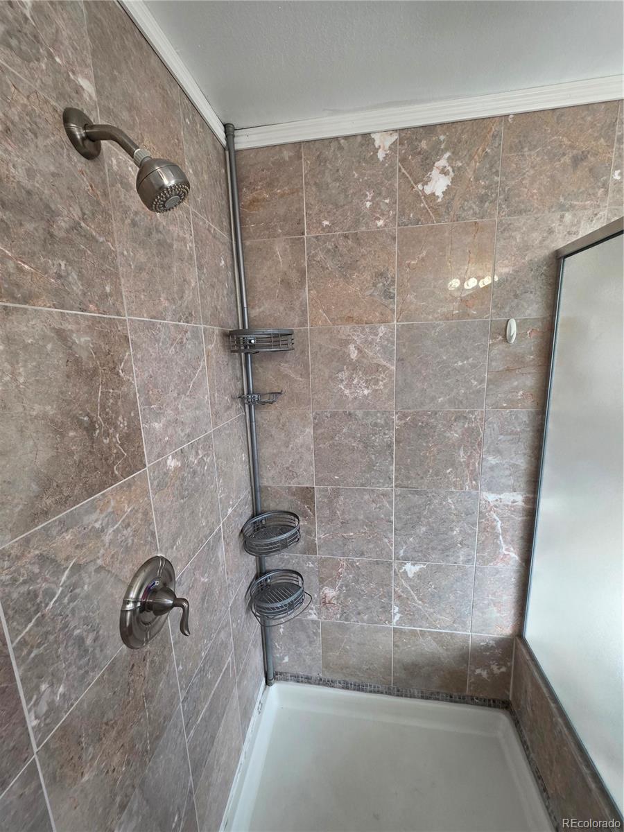 10439 Independence Street Broomfield, CO 80021 - Photo 14 of 30 a bathroom with a shower