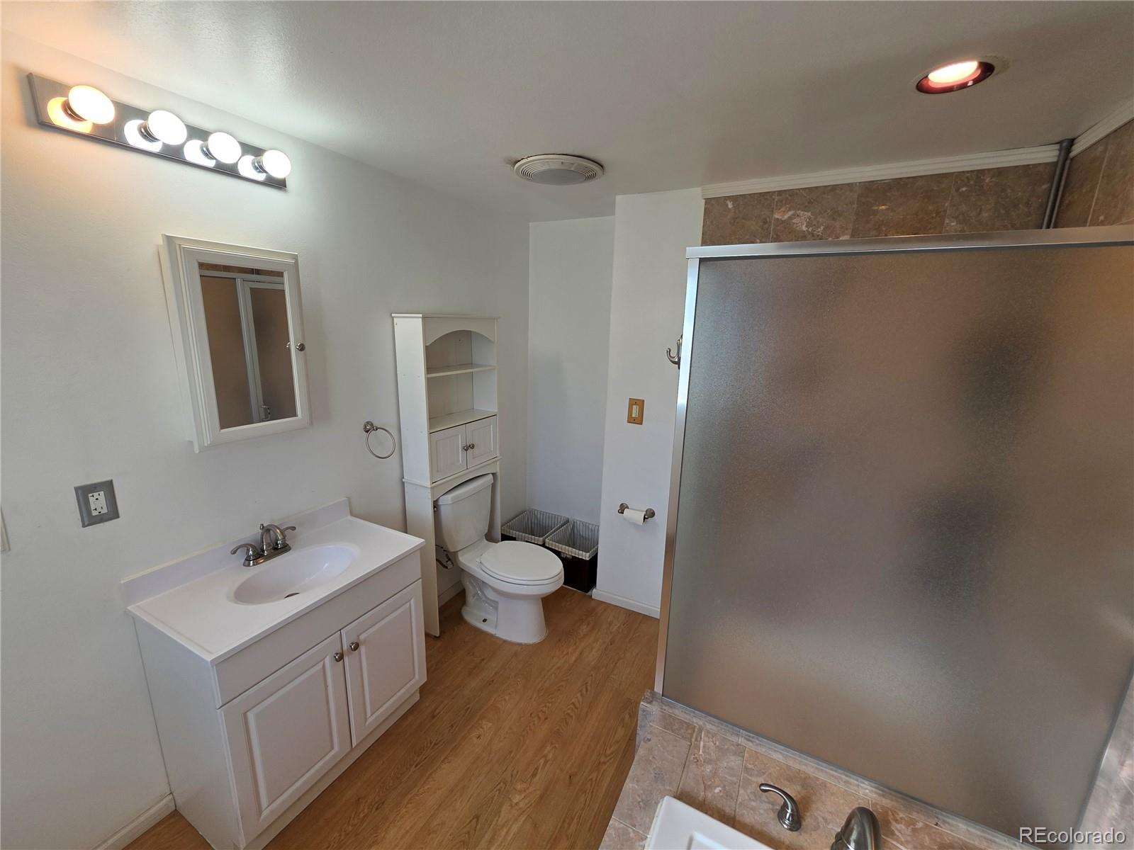 10439 Independence Street Broomfield, CO 80021 - Photo 16 of 30 a bathroom with a sink a toilet and shower