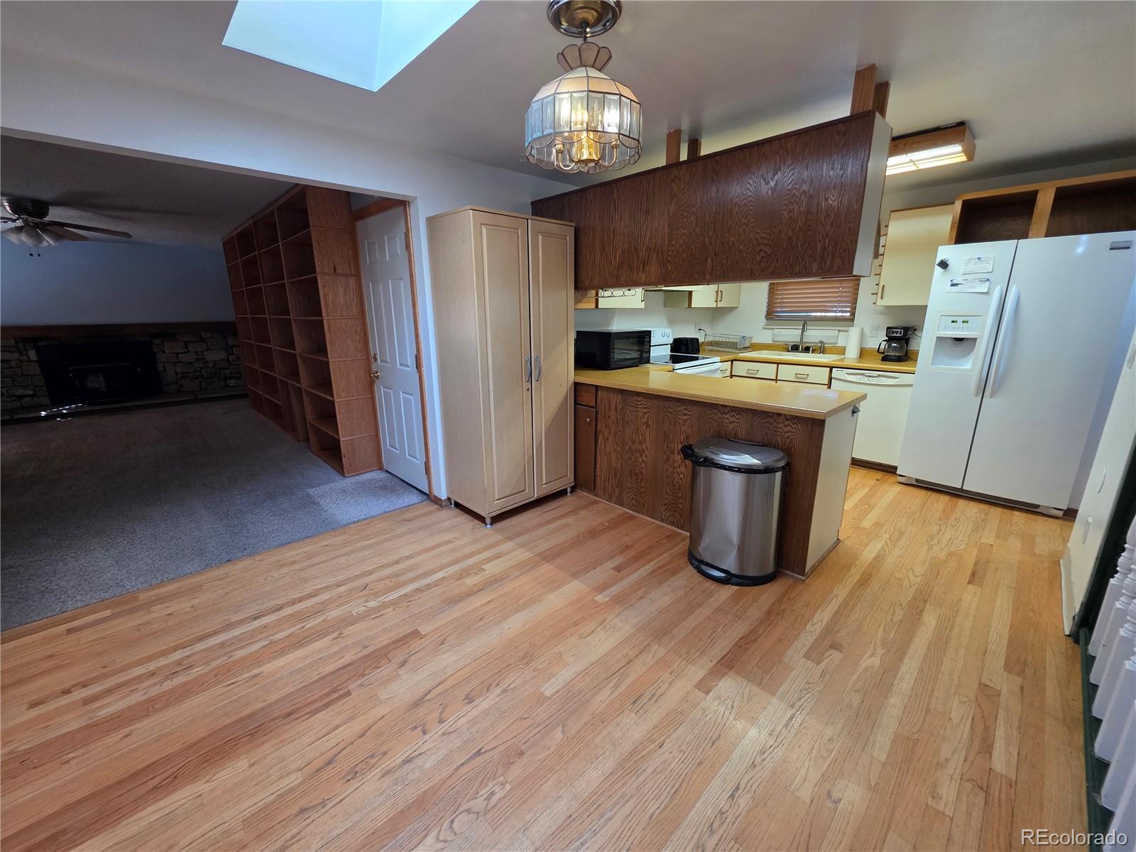 10439 Independence Street Broomfield, CO 80021 - Photo 4 of 30 a kitchen with stainless steel appliances granite countertop a refrigerator a stove and a wooden floors