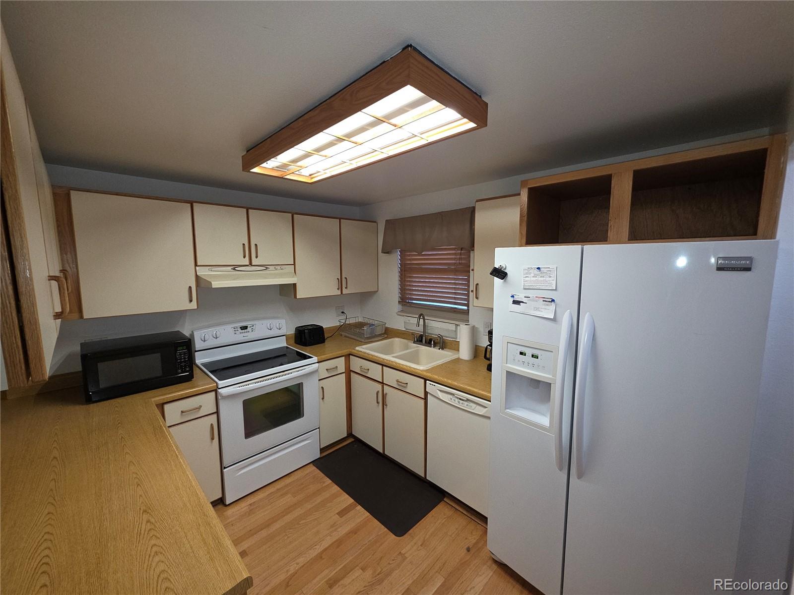 10439 Independence Street Broomfield, CO 80021 - Photo 6 of 30 a kitchen with a stove and a refrigerator