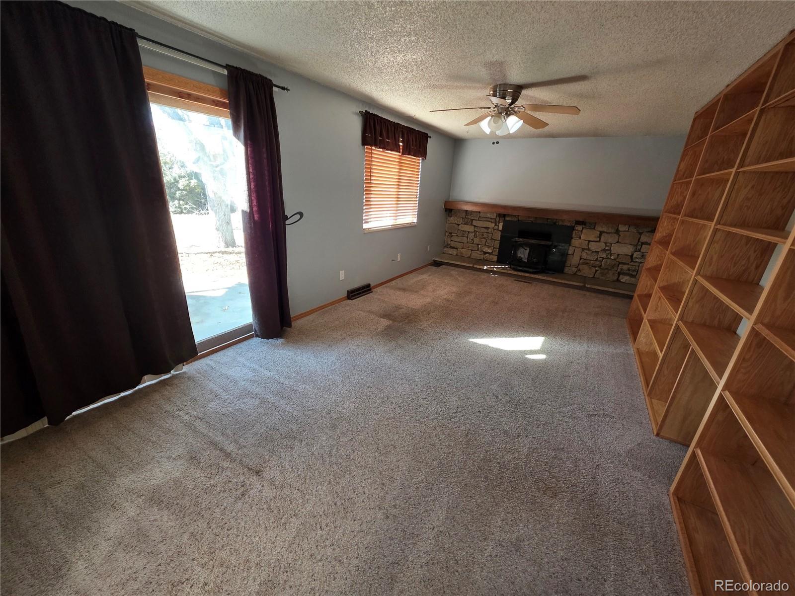 10439 Independence Street Broomfield, CO 80021 - Photo 7 of 30 a view of empty room with window and fireplace