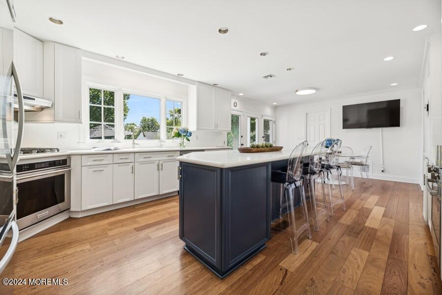 107 Rumson Road Rumson, NJ 07760 - Photo 12 of 46 a kitchen with a sink cabinets and wooden floor