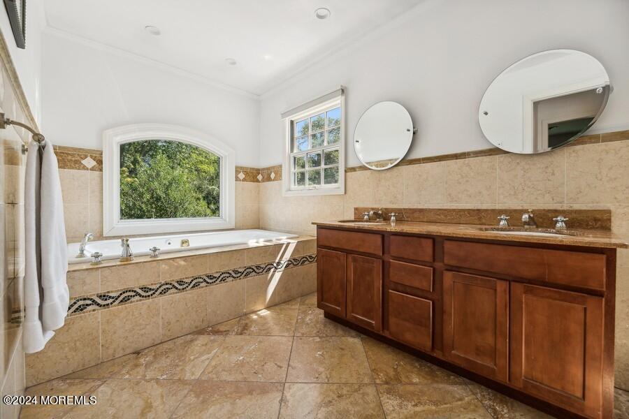 107 Rumson Road Rumson, NJ 07760 - Photo 21 of 46 a spacious bathroom with a tub sink and mirror