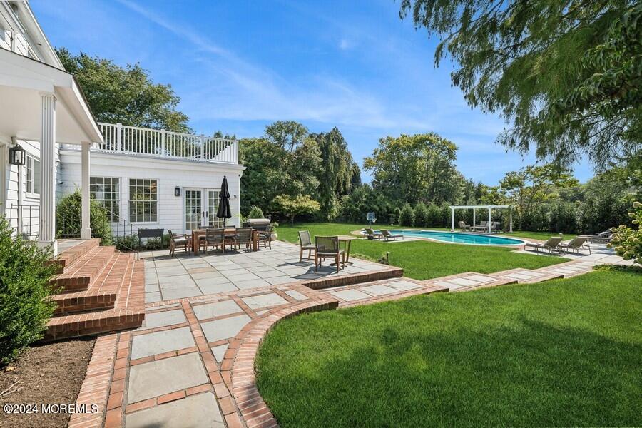 107 Rumson Road Rumson, NJ 07760 - Photo 32 of 46 a view of a patio with couches and table and chairs with wooden fence and plants