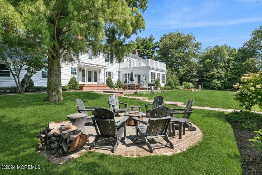 107 Rumson Road Rumson, NJ 07760 - Photo 33 of 46 a view of a house with backyard sitting area and garden
