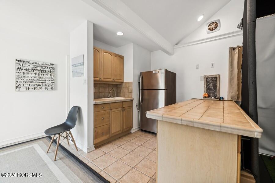 107 Rumson Road Rumson, NJ 07760 - Photo 38 of 46 a kitchen with a refrigerator a table and chairs