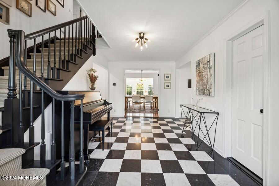 107 Rumson Road Rumson, NJ 07760 - Photo 4 of 46 a view of a hallway with a black white checkered floor and couches