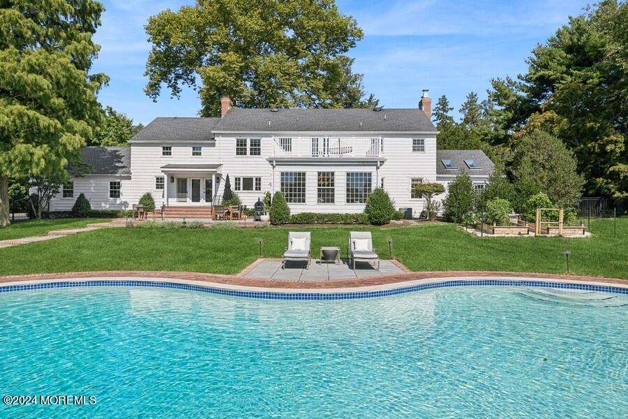 107 Rumson Road Rumson, NJ 07760 - Photo 41 of 46 a front view of a house with a yard table and chairs