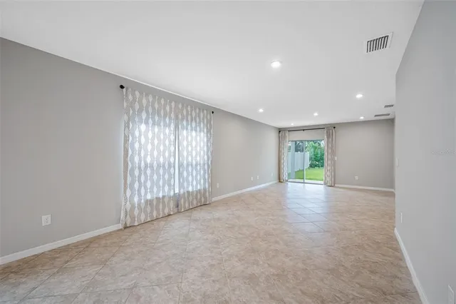 a view of kitchen and empty room