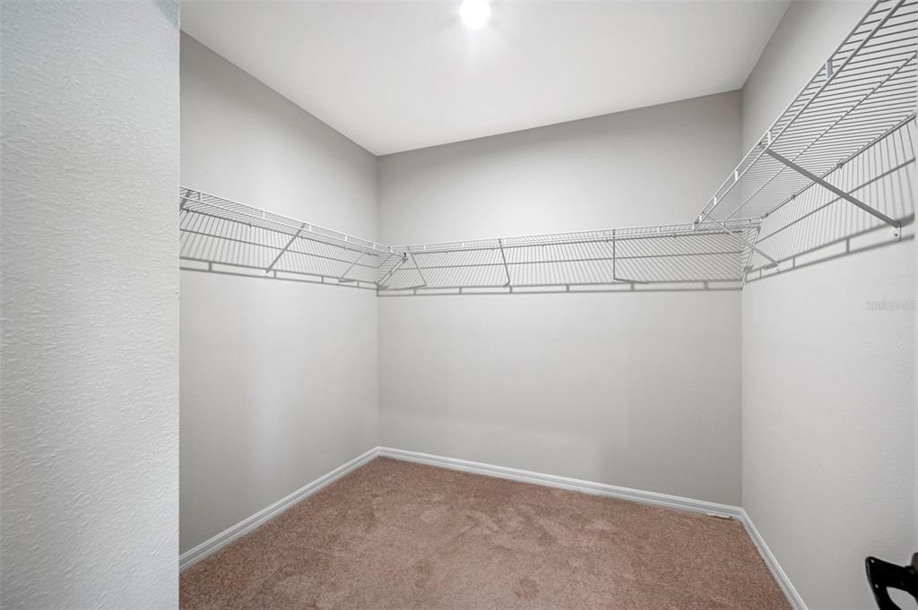 11230 High Noon Trail Parrish, FL 34219 - Photo 17 of 40 a view of a room with racks on the wall