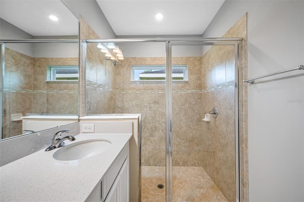 11230 High Noon Trail Parrish, FL 34219 - Photo 19 of 40 a bathroom with a sink shower and a mirror