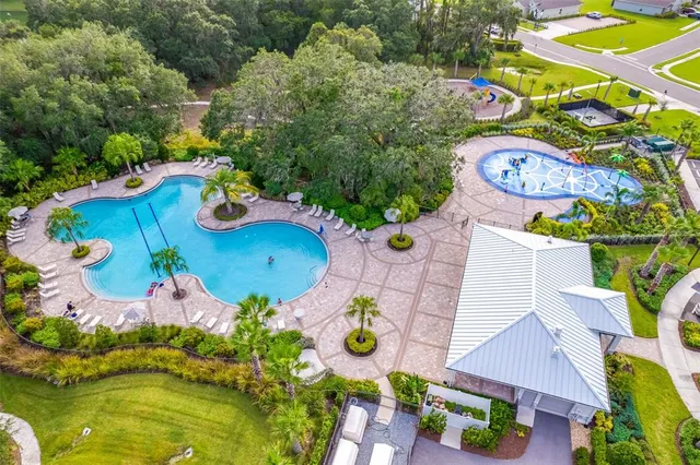 an aerial view of residential houses with outdoor space and swimming pool