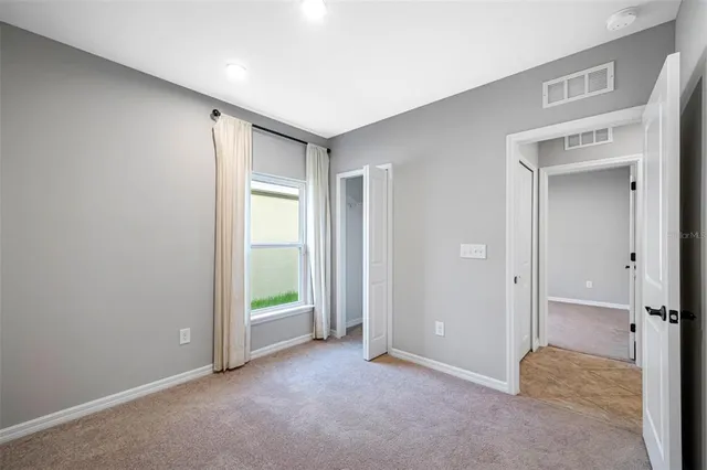 a view of an empty room and a window