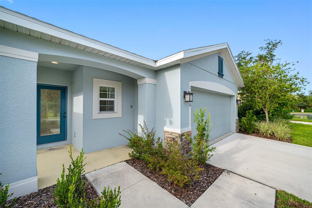 11230 High Noon Trail Parrish, FL 34219 - Photo 28 of 40 a front view of a house with garden