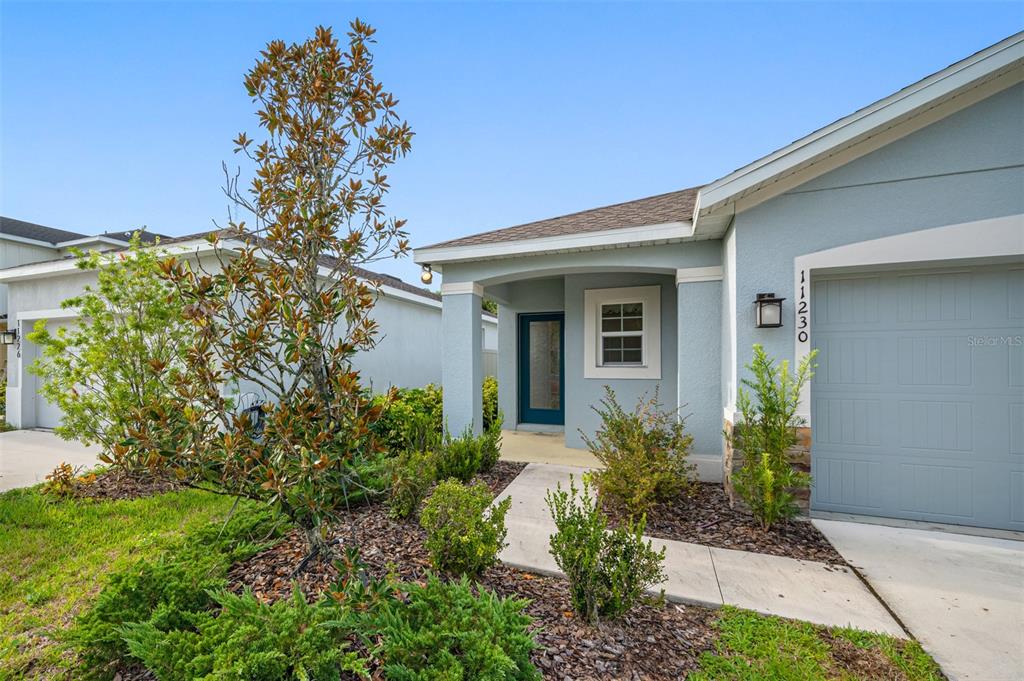 11230 High Noon Trail Parrish, FL 34219 - Photo 29 of 40 a front view of a house with garden