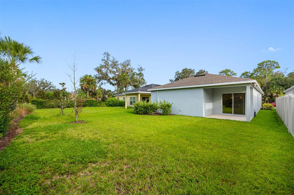 11230 High Noon Trail Parrish, FL 34219 - Photo 37 of 40 a front view of a house with garden