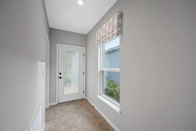 a view of hallway with window and front door